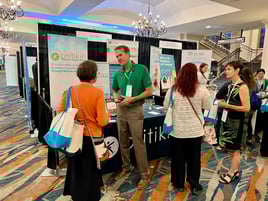 Jason Bole and Cindy Berner stand at the Pritikin booth at the ACLM 2024 conference