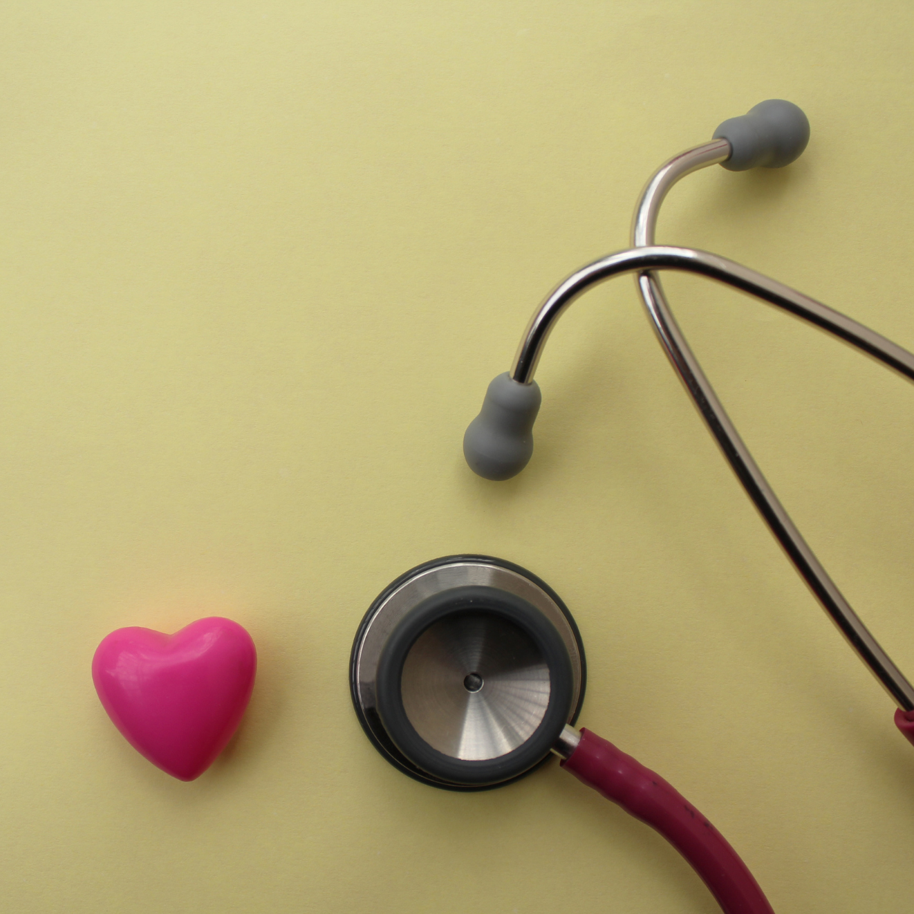 stethoscope with pink heart and yellow background_cropped