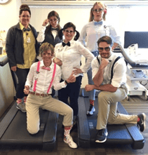Lynice Anderson and a former Renown Health ICR Dream Team dressed for halloween in white button-down shirts, bowties, khaki pants, and suspenders