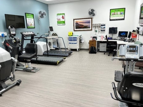 A room with exercise equipment and a corner desk with monitoring equipment in the corner- this is the exercise area in CentraCare Long Prairie cardiac rehab. 